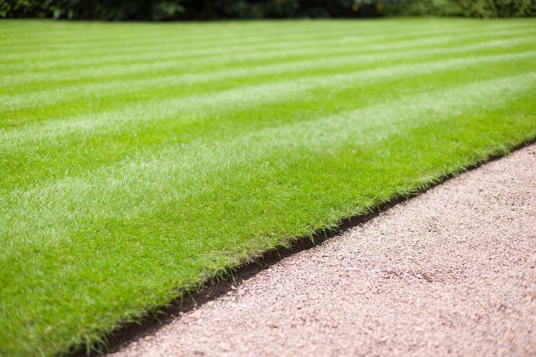 Beautiful, manicured lawn and garden path in a UK park or garden